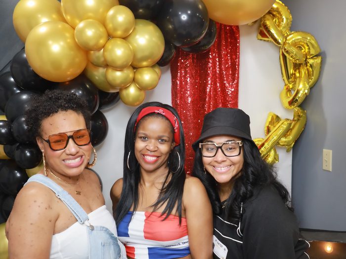 Friends at a birthday party photo booth