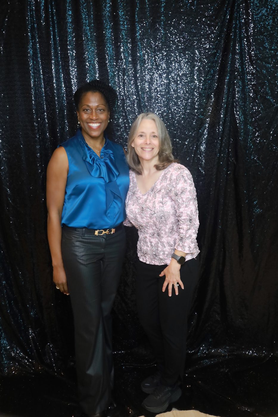 Two guests posing at a professional photo booth
