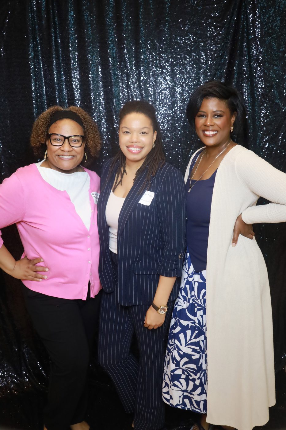 Three colleagues at a corporate event photo booth